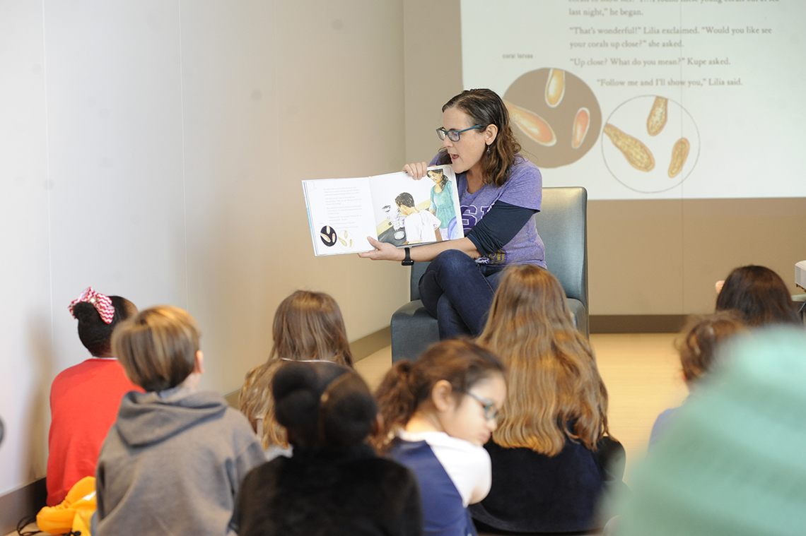 Dr. Morgan Kelly reading to kids for LSU Science STEM Story Time.